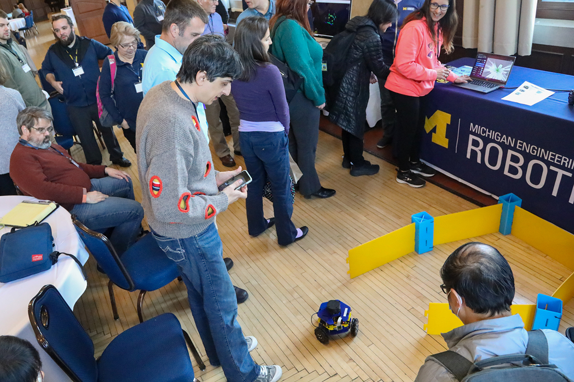 Participants take turns driving a robot on the floor of the Rogel Ballroom. Photograph by Joel Iverson, ITS Marketing and Communications